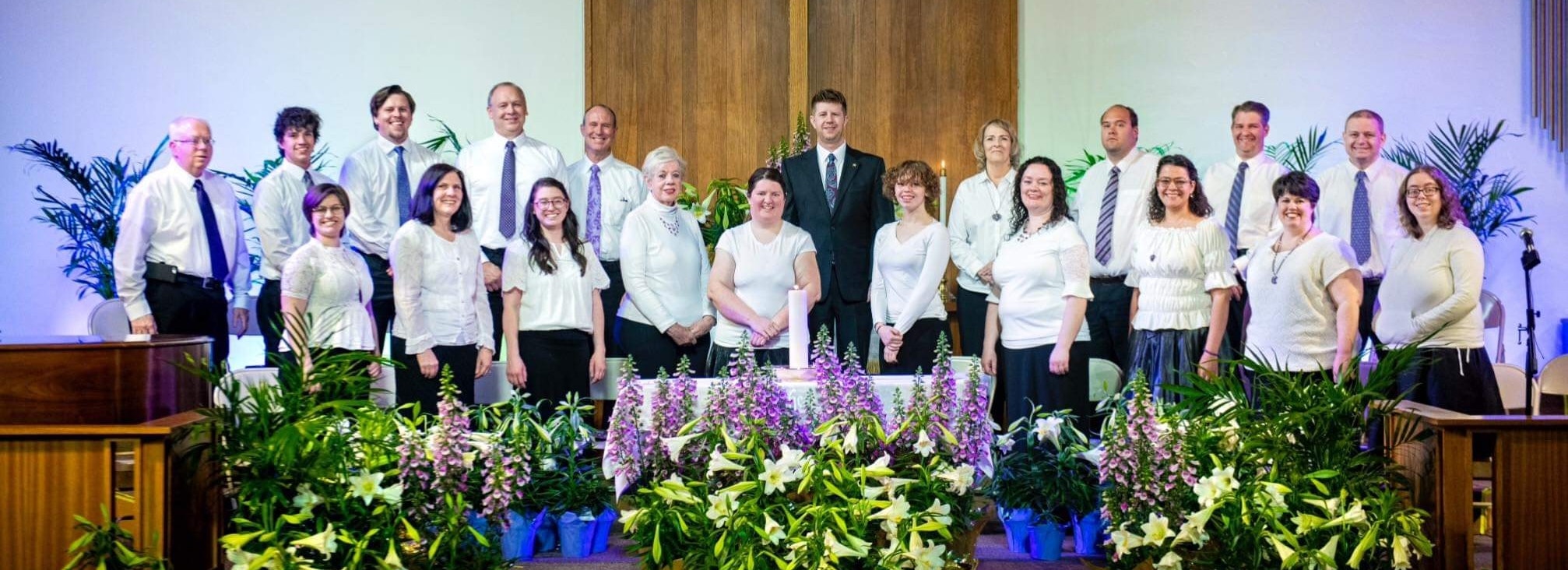 Utah Valley Interfaith Choir members singing in a community church. Members are of various ages and backgrounds. 
